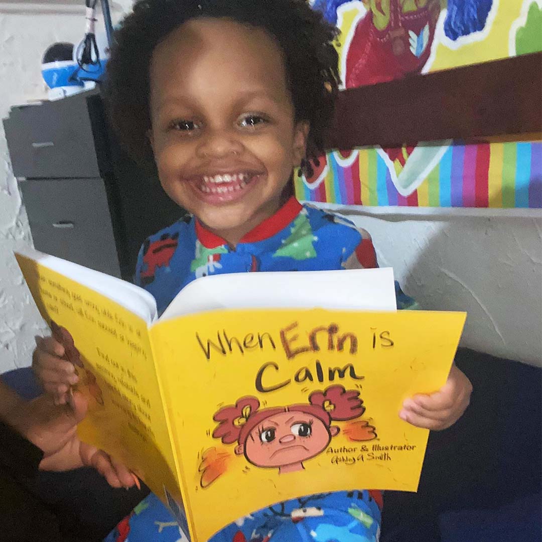 Boy happily reading children's book